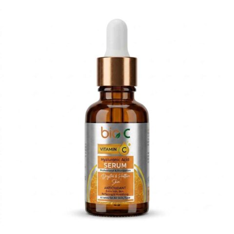Glass dropper bottle of vitamin C hyaluronic acid serum for glowing skin